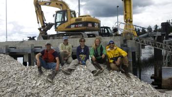 Oyster restoration crew on shell pile